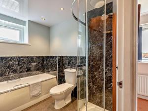 a bathroom with a toilet and a shower at 3 Bed in Keswick oc-sz047 in Threlkeld +14 photos