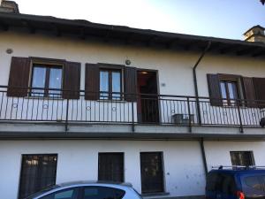 a building with balconies and cars parked in front of it at Casa Camilla CIR 0058 in Aosta