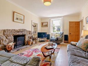 a living room with a couch and a fireplace at 3 Bed in Lochgelly oc-ff224 in Kinglassie