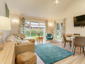 a living room with a couch and a table at 2 Bed in Swansea oc-91725 in Killay