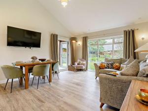 a living room with a couch and a table at 2 Bed in Swansea oc-91726 in Killay