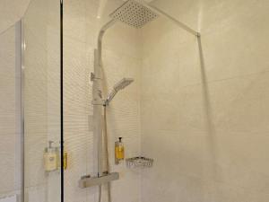 a shower with a glass door in a bathroom at 2 Bed in Swansea oc-91726 in Killay +10 photos