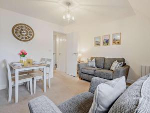 a living room with a table and a couch at 2 Bed in Keswick oc-91901 in Keswick