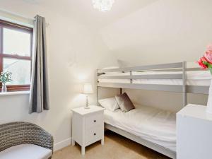 a bedroom with two bunk beds and a window at 2 Bed in Keswick oc-91901 in Keswick