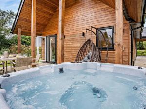 a large hot tub in front of a house at 3 Bed in Swansea oc-91722 in Killay