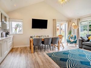 a kitchen and dining room with a table and chairs at 3 Bed in Swansea oc-91722 in Killay