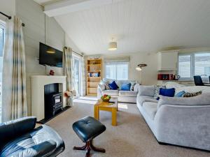 a living room with two couches and a fireplace at 2 Bed in Narberth oc-91799 in Stepaside