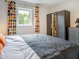 a bedroom with a bed and a window and a dresser at 3 Bed in Swansea oc-91722 in Killay +15 photos