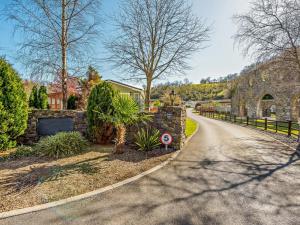a street with a stone wall and a driveway at 2 Bed in Narberth oc-91799 in Stepaside