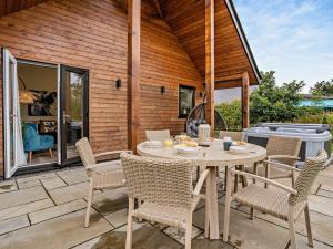 a patio with a table and chairs and a grill at 3 Bed in Swansea oc-91722 in Killay