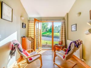 two chairs in a living room with a balcony at 3 Bed in Appleby-in-westmorland oc-93200 in Colby