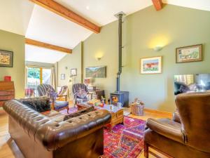 a living room with a leather couch and a fireplace at 3 Bed in Appleby-in-westmorland oc-93200 in Colby