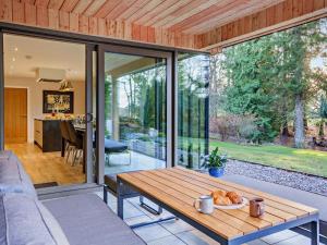 a glass extension of a house with a table at 4 Bed in Aberdeen oc-93914 in Dyce