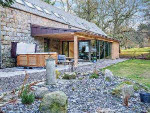 a stone house with a tub in a yard at 4 Bed in Aberdeen oc-93914 in Dyce