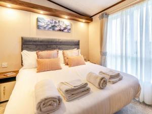 a bedroom with a large white bed with towels on it at 2 Bed in St. Andrews oc-90763 in St. Andrews