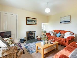 a living room with couches and a fireplace at 3 Bed in Archiestown oc-ca227 in Carron