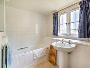 a bathroom with a sink and a bath tub and a sink at 3 Bed in Archiestown oc-ca227 in Carron +22 photos