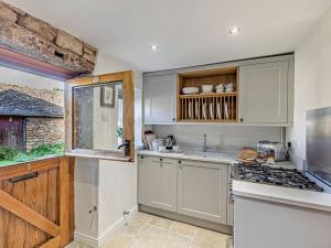 a kitchen with a sink and a stove top oven at 1 Bed in Chipping Campden oc-93393 in Chipping Campden