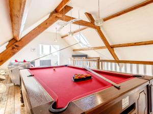 a red pool table in a room with wooden ceilings at 2 Bed in Ellesmere oc-62544 in Ellesmere