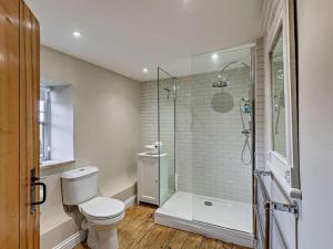 a bathroom with a toilet and a glass shower at 1 Bed in Chipping Campden oc-93393 in Chipping Campden +11 photos