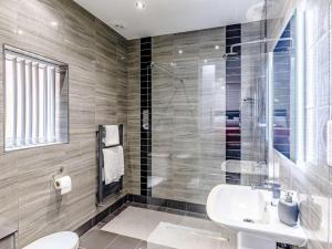 a bathroom with a sink and a toilet and a shower at 2 Bed in Ellesmere oc-62544 in Ellesmere +17 photos