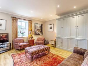 a living room with a couch and two chairs at 1 Bed in Forres oc-78430 in Forres