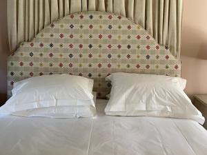 a bed with a headboard and two pillows at 1 Bed in Forres oc-78430 in Forres