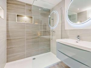 a bathroom with a shower with a sink and a mirror at 3 Bed in Callander oc-79359 in Callander +15 photos