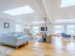 a living room with a white couch and a fireplace at 4 Bed in Dunoon oc-79529 in Ardentinny