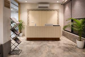 an office lobby with a reception desk and plants at OPO Premier Marvel in Jaipur +31 photos