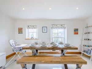 a dining room with a table and a chair at 4 Bed in Dunoon oc-79529 in Ardentinny
