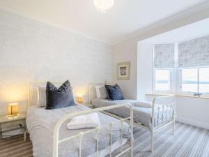 a bedroom with two beds and a window at 4 Bed in Dunoon oc-79529 in Ardentinny