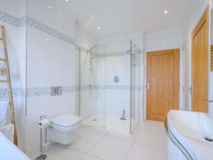 a bathroom with a shower and a toilet and a sink at 4 Bed in Dunoon oc-79529 in Ardentinny +21 photos