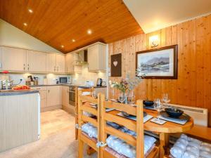 a kitchen and dining room with a table and chairs at 3 Bed in Penrith oc-88212 in Tirril