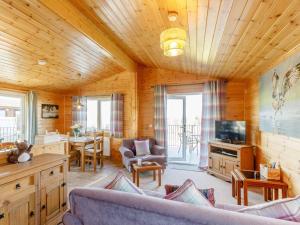 a living room with a couch and a tv and a table at 2 Bed in Kinross oc-82297 in Kinross