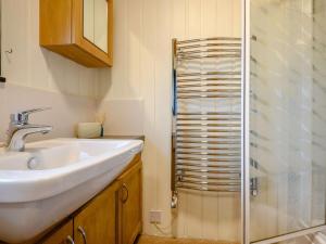 a bathroom with a sink and a shower at 3 Bed in Penrith oc-88212 in Tirril +8 photos