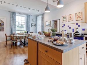 a kitchen with a counter and a dining room with a table at 5 Bed in Blairgowrie oc-ca409 in Cray