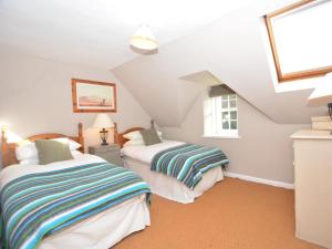 a attic bedroom with two beds and a window at 2 Bed in Duns oc-48811 in Duns