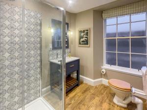 a bathroom with a shower and a toilet and a window at 5 Bed in Blairgowrie oc-ca409 in Cray +39 photos