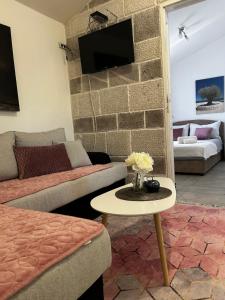 a living room with a couch and a table at Apartmani Gušti in Kamenari