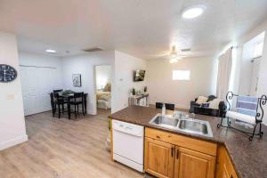 a kitchen with a sink and a living room at Maple Canyon w/Kitchen&wash+dry in Mount Pleasant