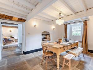 a dining room with a table and chairs and a fireplace at 4 Bed in Leyburn oc-g0008 in Gammersgill