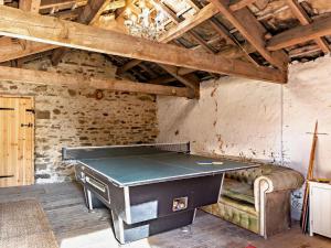a ping pong table in a room with a couch at 4 Bed in Leyburn oc-g0008 in Gammersgill
