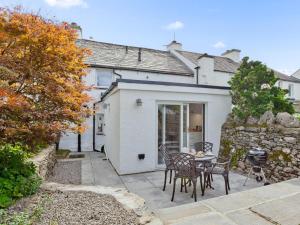 a house with a patio and a table and chairs at 1 Bed in Grange-over-sands oc-78659 in Cartmel