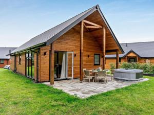 a wooden house with a patio and a grill at 3 Bed in Swansea oc-91729 in Killay
