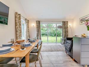 a dining room with a table and chairs and a living room at 3 Bed in Swansea oc-91729 in Killay