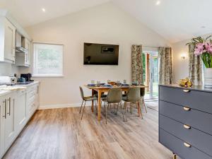 a kitchen with a dining room table and chairs at 3 Bed in Swansea oc-91729 in Killay +13 photos