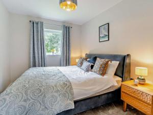 a bedroom with a bed and a window at 3 Bed in Swansea oc-91729 in Killay