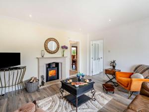 a living room with a couch and a fireplace at 3 Bed in Falkirk oc-96124 in Avonbridge