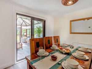 a dining room with a table with dishes on it at 3 Bed in Falkirk oc-96124 in Avonbridge